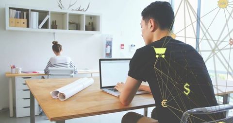 Asian Man Using Laptop with Conceptual Digital Overlay in Modern Office