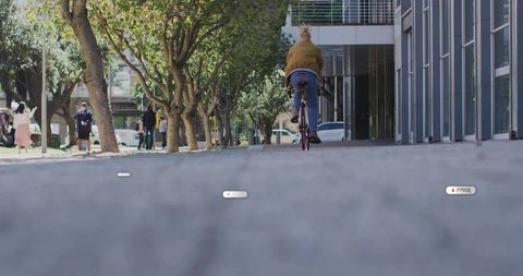 Urban Cyclist Enjoying Modern City Ride Near Glass Architecture