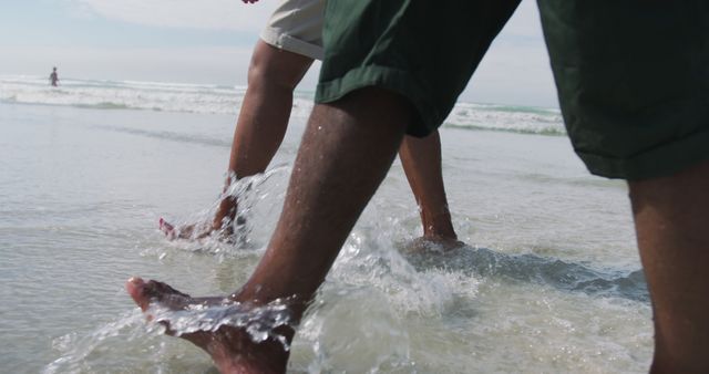 Couple Walking Barefoot on Beach in Shallow Water at Sunset - Download Free Stock Images Pikwizard.com