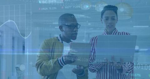 Business Professionals Analyzing Digital Stock Data in Office Setting