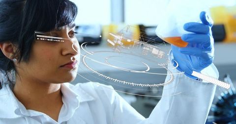 Scientist analyzing orange liquid in erlenmeyer flask with augmented reality interface