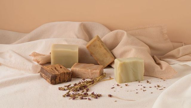 Handmade natural soap bars on draped linen with dried lavender minimalist spa styling