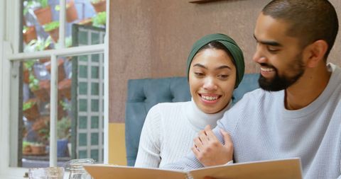 Couple Enjoying a Cozy Meal in Restaurant