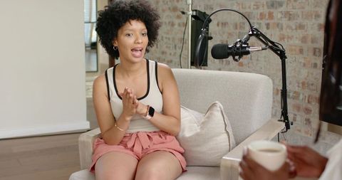 African american woman hosting casual podcast interview in home studio