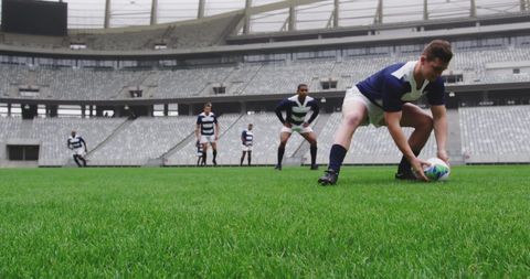 Group of Rugby Players Practicing in Stadium