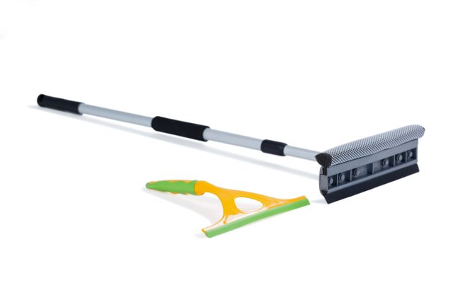 Squeegee and floor mop arranged on white background