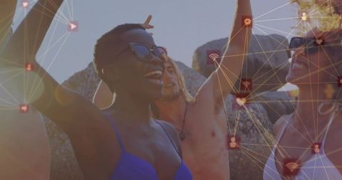Dancing friends celebrating on rocky beach with digital social network overlay