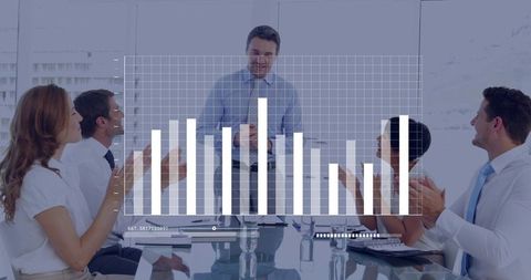 Executive presenting bar chart in modern boardroom while team applauding