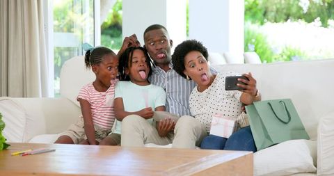 Playful Family Taking Selfie on Cozy Living Room Couch