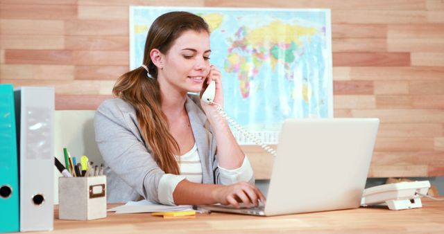 Young Businesswoman on Phone Call While Working on Laptop in Office - Download Free Stock Images Pikwizard.com