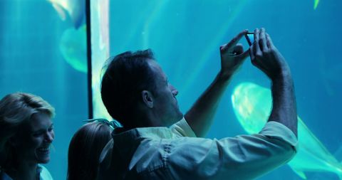 Visitors capturing memories at scenic aquarium display