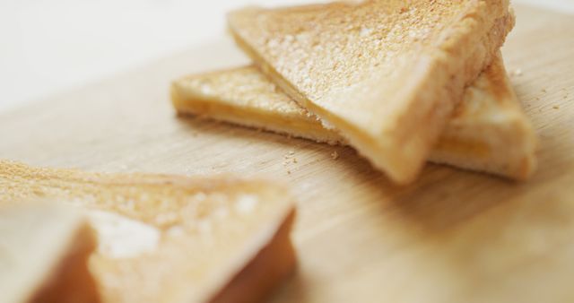 Image of slices of toasted cheese white bread sandwiches on wooden chopping board background. fusion food and fresh homemade snack concept.