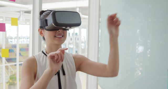 Woman Using Virtual Reality Goggles in Office - Download Free Stock Images Pikwizard.com