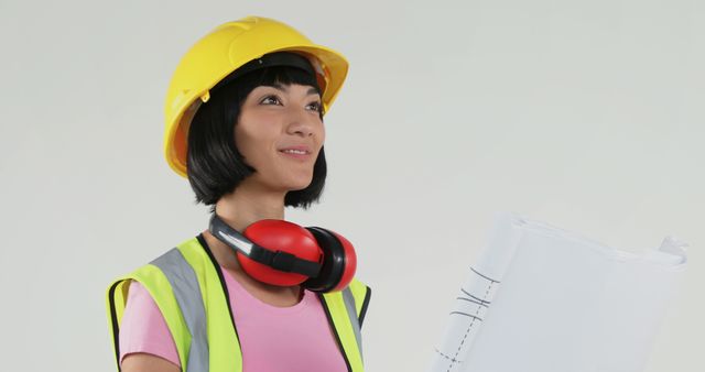 Female Construction Engineer Holding Blueprint in Safety Gear - Download Free Stock Images Pikwizard.com