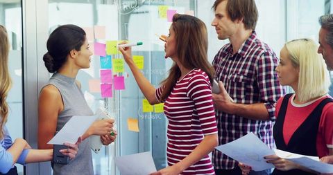 Creative team brainstorming with colorful sticky notes and marker-led ideation