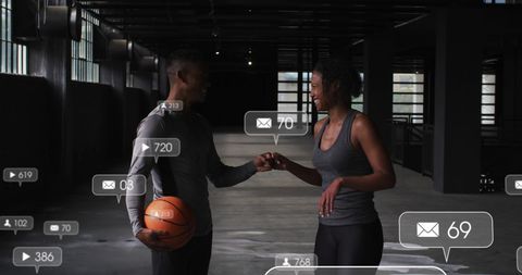 Couple with Social Media Notifications Exchanging Fist Bump in Urban Setting