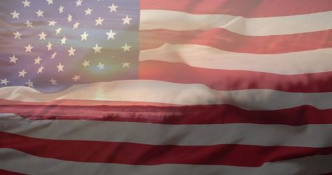 Waving american flag over coastal sunset double exposure with stars stripes horizon