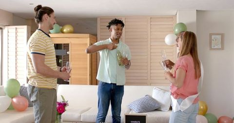 Friends Celebrating at Home with Champagne Toast