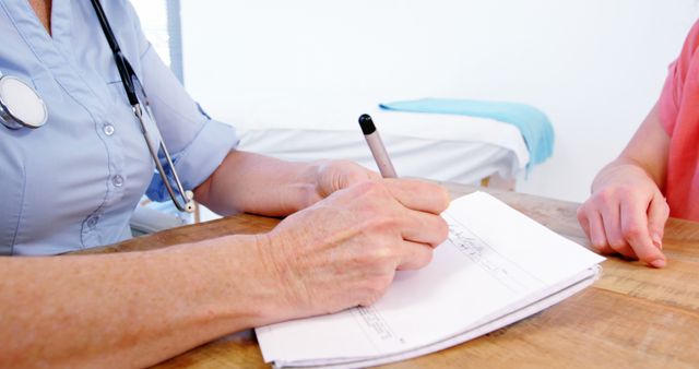 Doctor Writing Prescription for Patient in Clinic - Download Free Stock Images Pikwizard.com