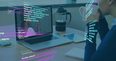 Navy-sweater woman sipping coffee while reviewing code on laptop with holographic overlay