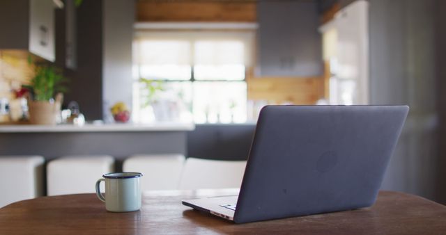 Laptop and Coffee Cup on Wooden Table in Cozy Kitchen - Download Free Stock Images Pikwizard.com