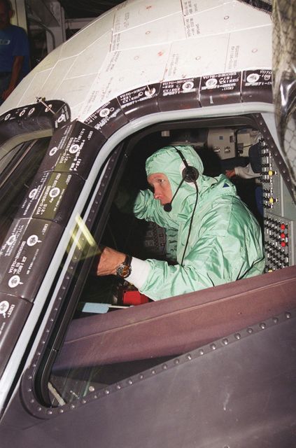 Scene of an astronaut engaging in cockpit inspection as part of the Crew Equipment Interface Test (CEIT) for Space Shuttle Endeavour at Kennedy Space Center, Florida. Suitable for content about space exploration, NASA missions, astronaut training, and space shuttle operations. Ideal for educational materials detailing space mission preparations and human spaceflight activities.