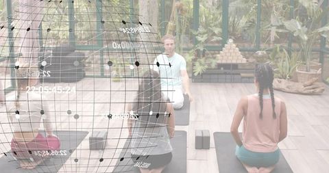 Leading instructor guiding yoga class in glass studio with augmented reality globe overlay