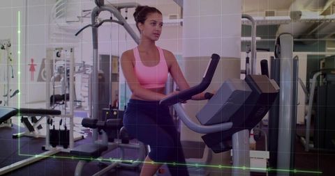 Focused Woman Exercising on Stationary Bike in Gym
