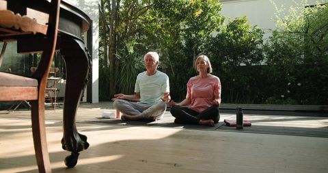 Senior Couple Meditating Outdoors Near Home