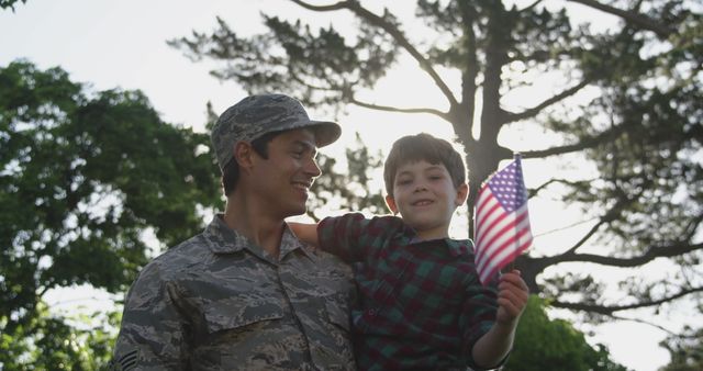 Smiling Soldier Holding Young Boy with American Flag Outdoors - Download Free Stock Images Pikwizard.com