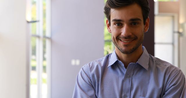 Confident Young Businessman Smiling in Modern Office - Download Free Stock Images Pikwizard.com