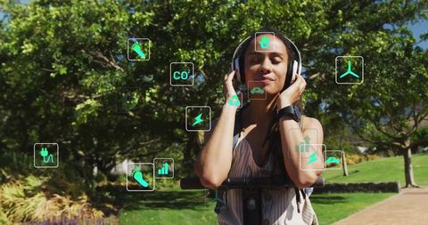 Woman Enjoys Music in Park with Sustainable Technology Symbols