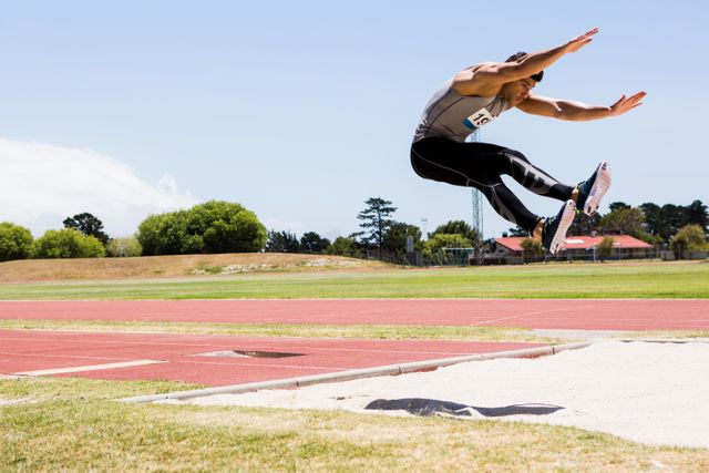 Athlete performing a long jump - Download Free Stock Photos Pikwizard.com