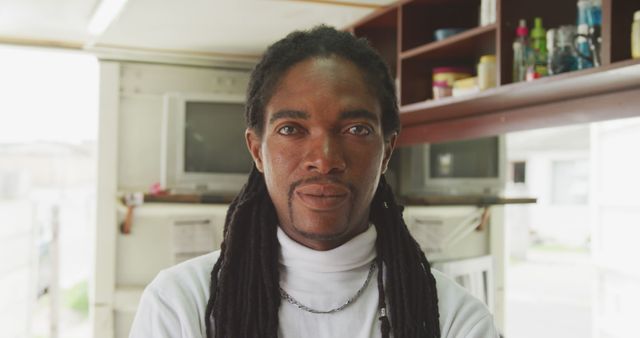 Confident African American man with dreadlocks in office space - Download Free Stock Images Pikwizard.com