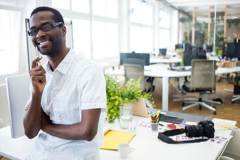 Smiling Professional in Modern Office Ready for Work
