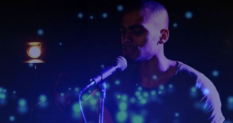 Vocalist performing with dramatic lighting and light effects