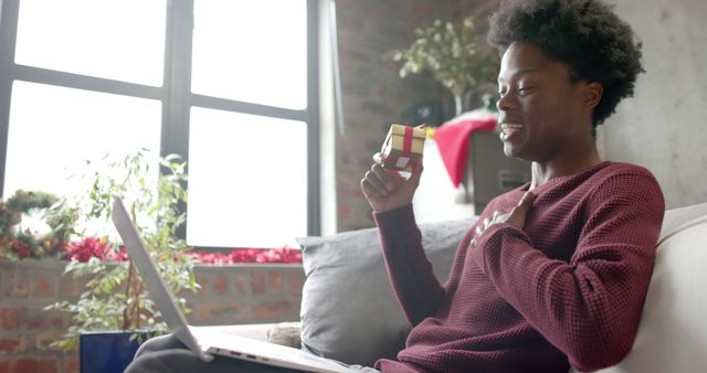 Person Smiling and Receiving Gift During Video Call at Home - Download Free Stock Images Pikwizard.com