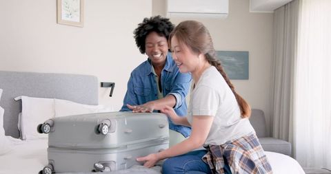 Joyful Interracial Couple Packing for Vacation