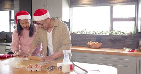 Father and daughter enjoy holiday baking in festive kitchen