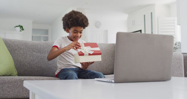 Joyful Child Unwrapping Gift on Video Call at Home - Download Free Stock Images Pikwizard.com