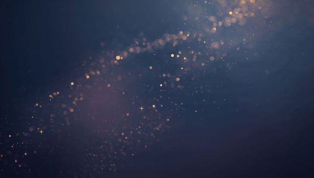 Glowing golden bokeh trail drifting across deep blue background with sparkling particles