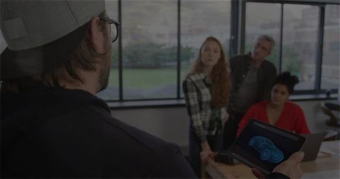 Creative Team Analyzing Car Design Using Tablet Technology