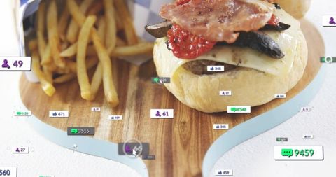 Cheeseburger and fries on wooden board showing social media engagement overlay and cursor