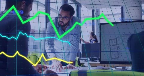 Middle eastern architect reviews blueprints with data visualization