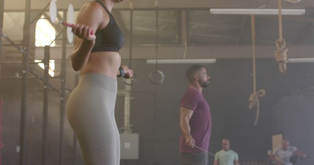 Athletic Individuals Exercising with Jump Ropes in Gym - Download Free Stock Images Pikwizard.com