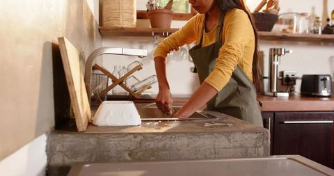 Woman Washing Dishes in Rustic Modern Kitchen Interior