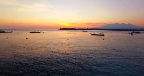 Tranquil Sunset Over Serene Ocean Waters with Boats - Download Free Stock Images Pikwizard.com
