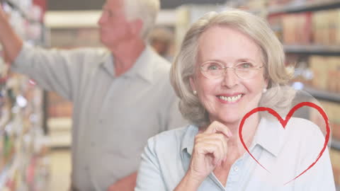 Smiling Senior Couple in Supermarket with Heart Overlay