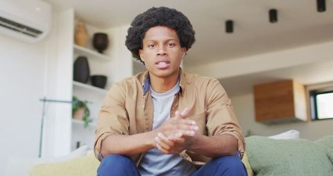 Man Engages in Video Call in Modern Living Room Interior