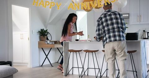 Couple Cleaning Up After Anniversary Celebration at Home